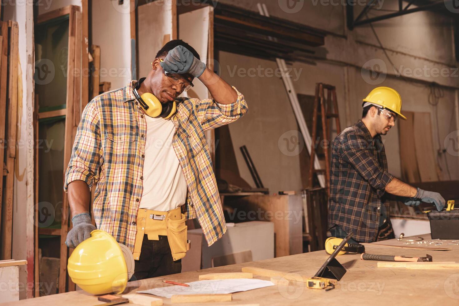 tired fatigue hard work worker in wood workshop factory sweating hot weather photo
