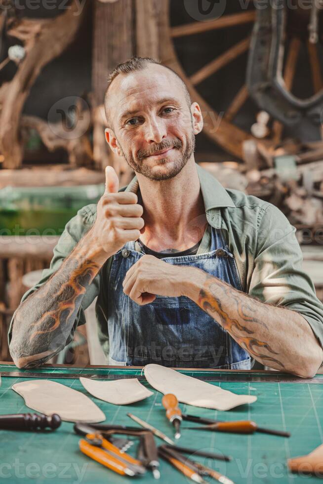 portrait happy artist leather handcraft working at own workshop small studio made by order masterwork piece photo