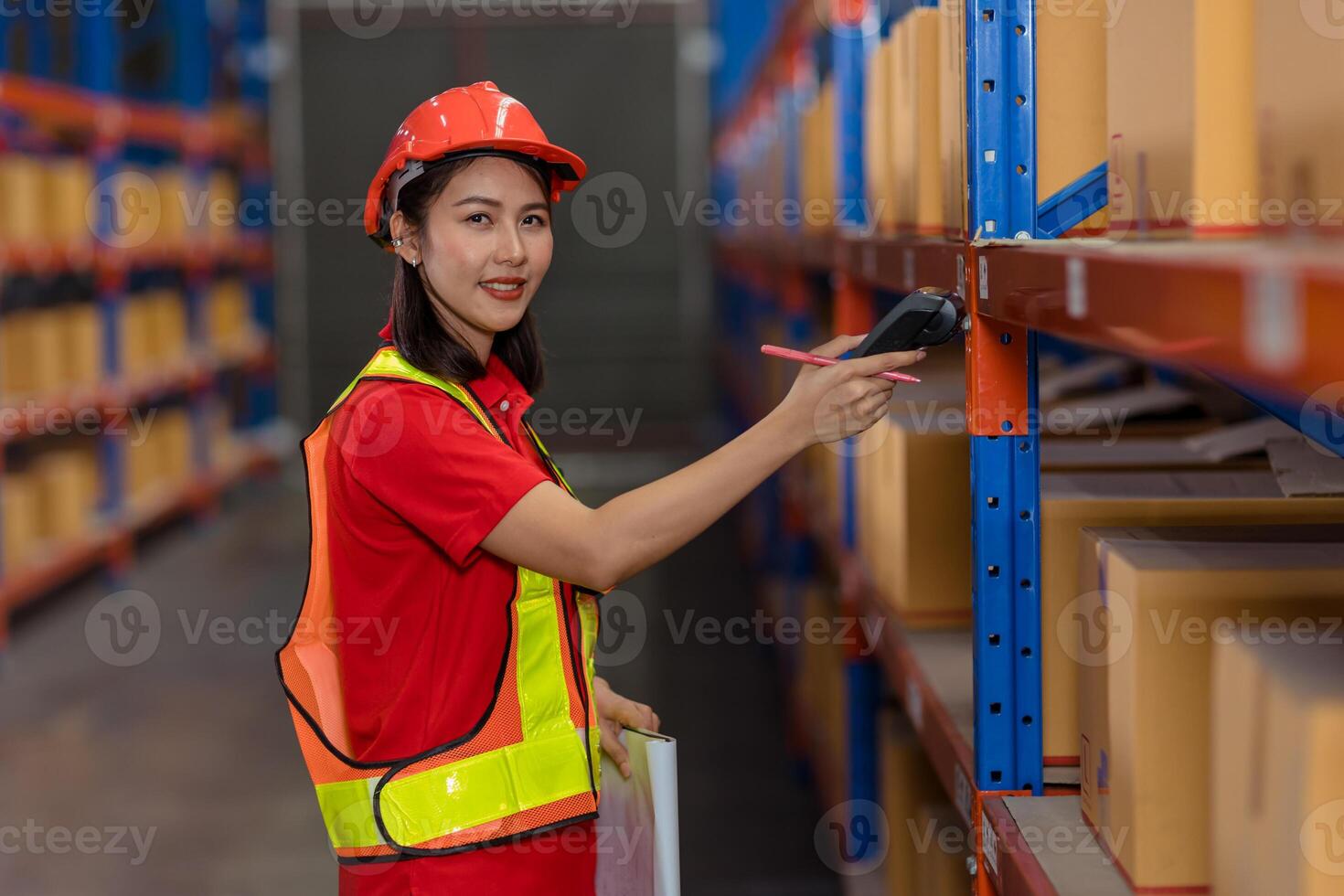 Portrait Asian worker warehouse stock control staff work checking inventory amount using bar code scanner photo