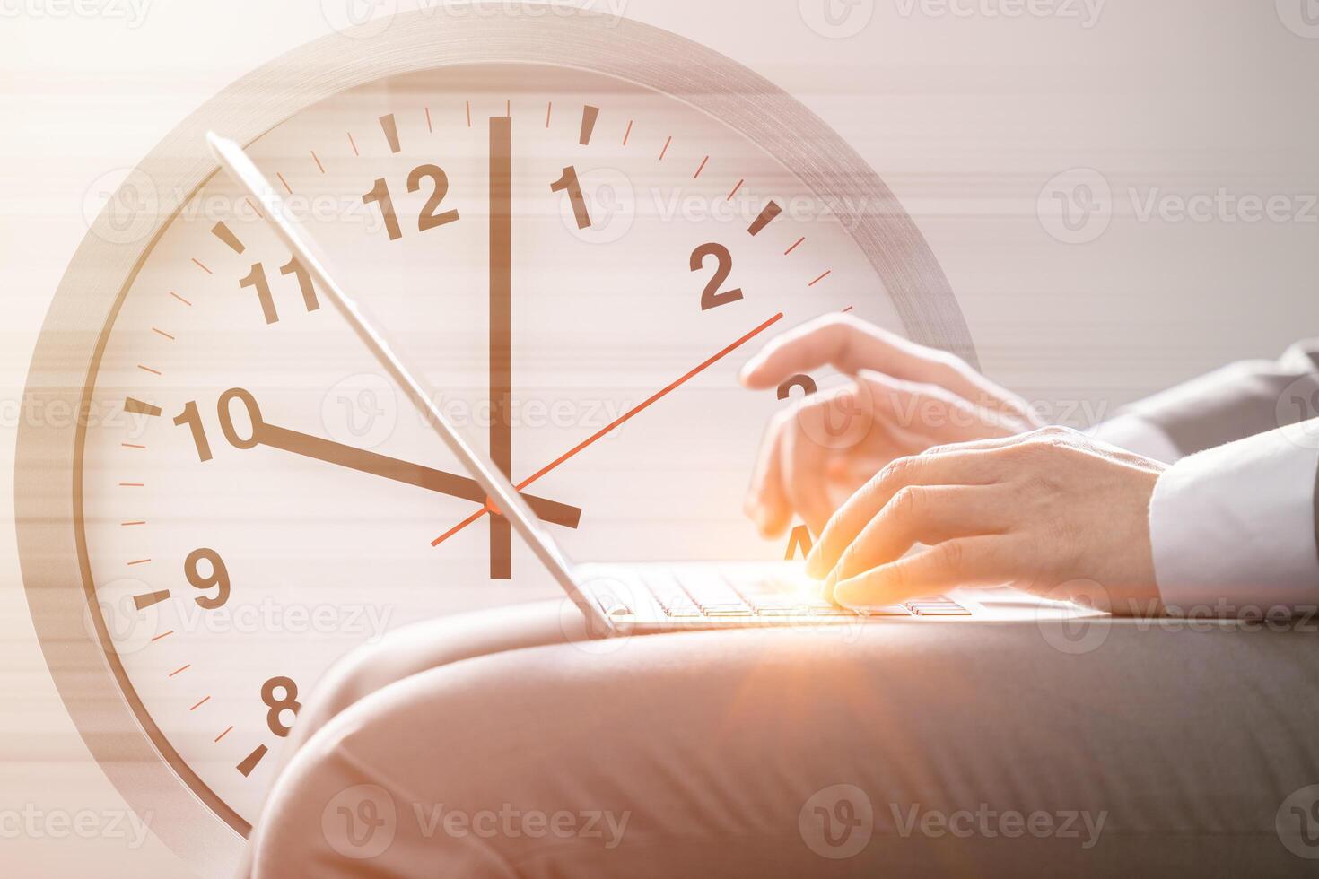 business work on time fast speed working concept. hand typing on laptop computer against times clock face for office hours morning. photo