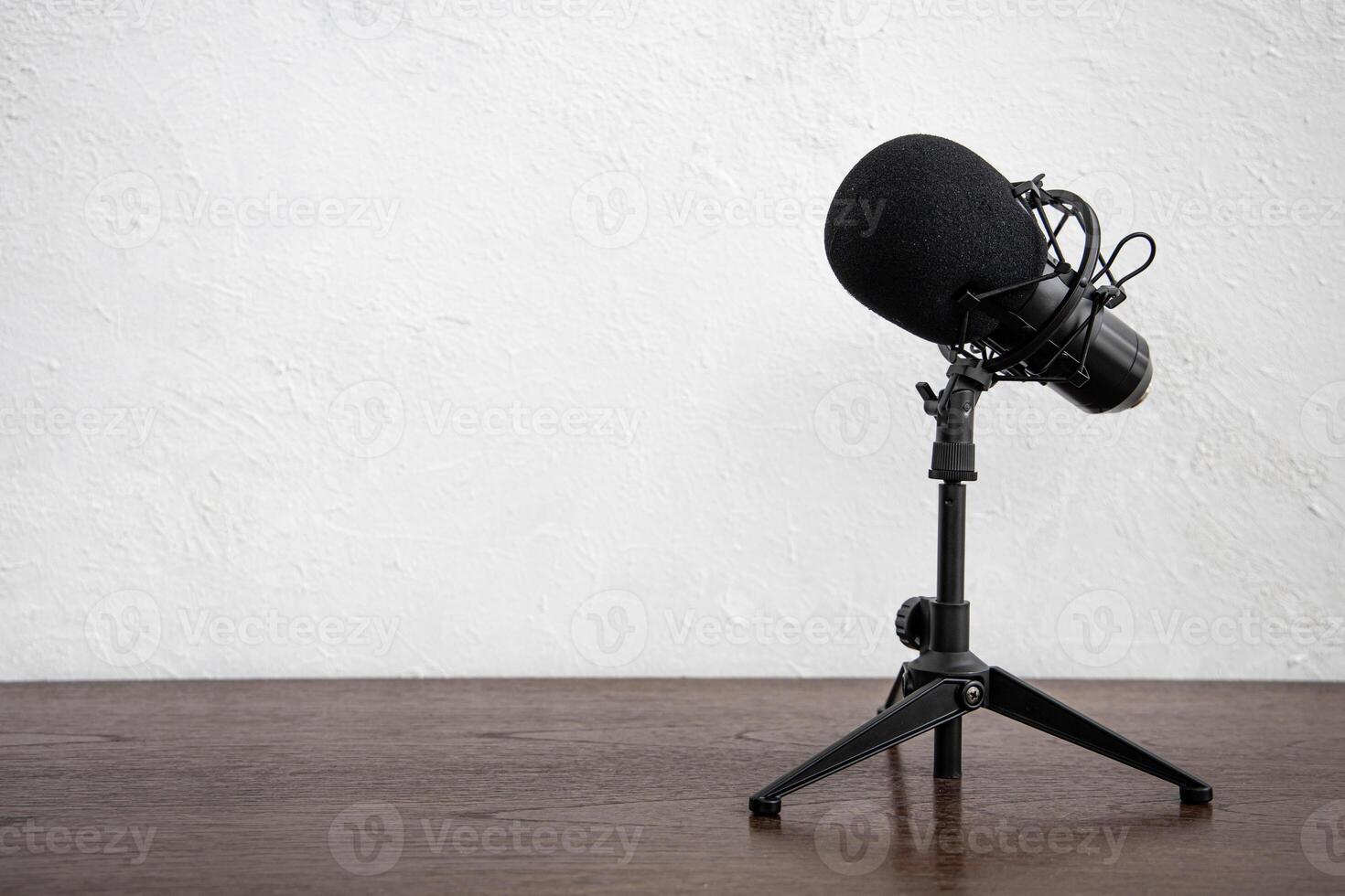 Studio Condenser Microphone for home studio radio podcast isolated on white wall wooden table background space for text. photo