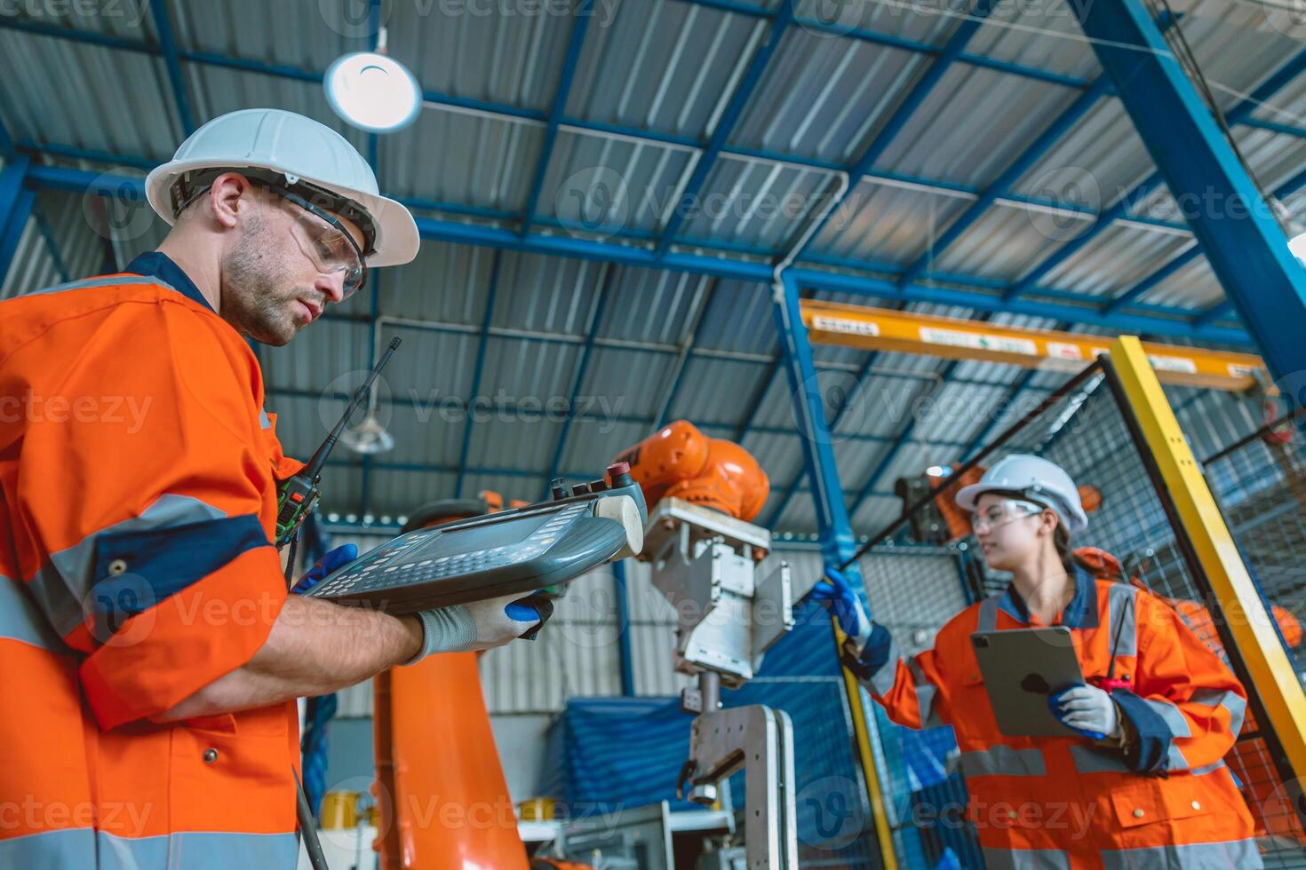 engineer team service programming automated robotic welding arm in modern heavy industry factory photo