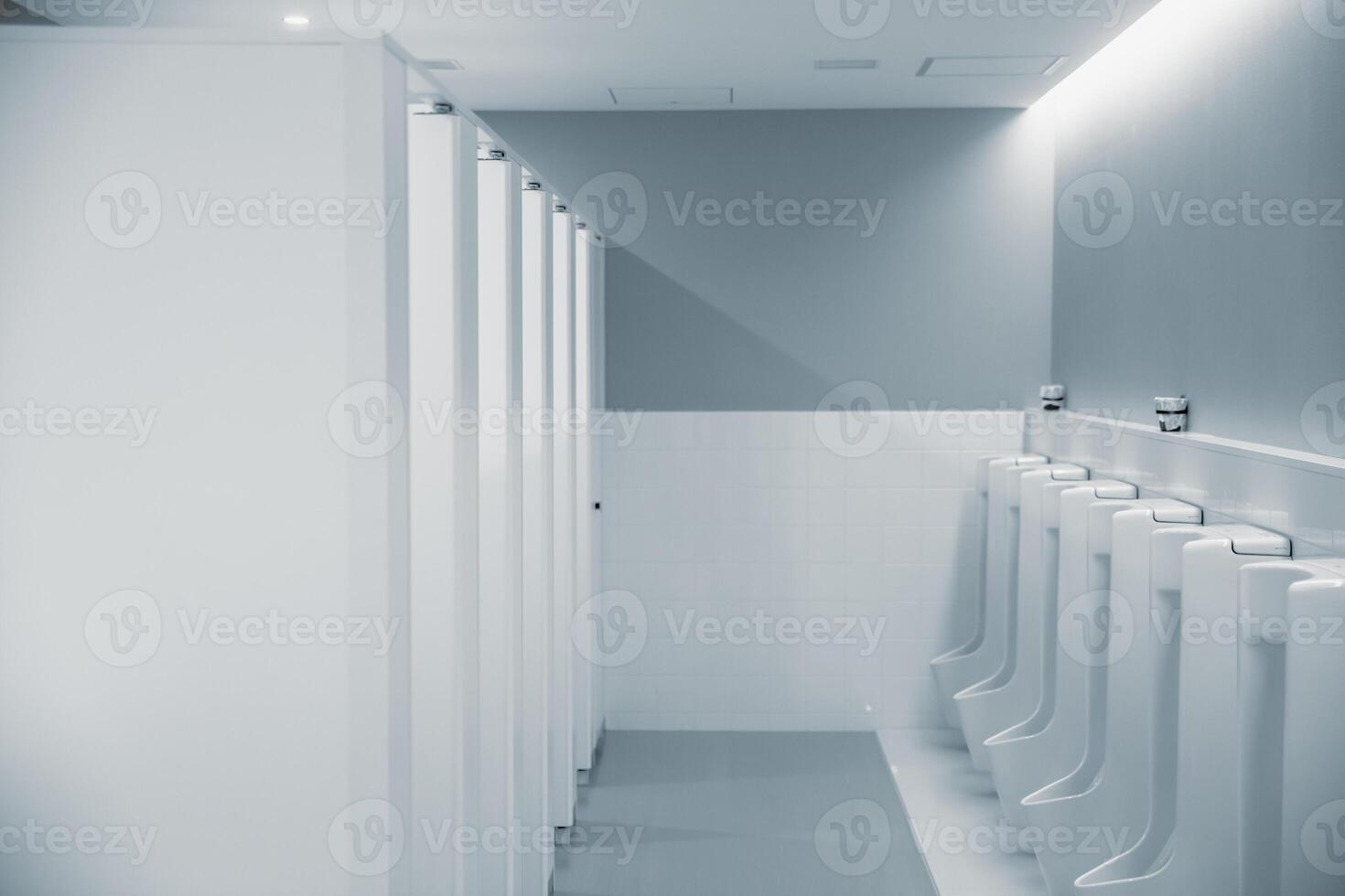 men restroom with row of urinal bowl clean modern style public toilet in office interior photo