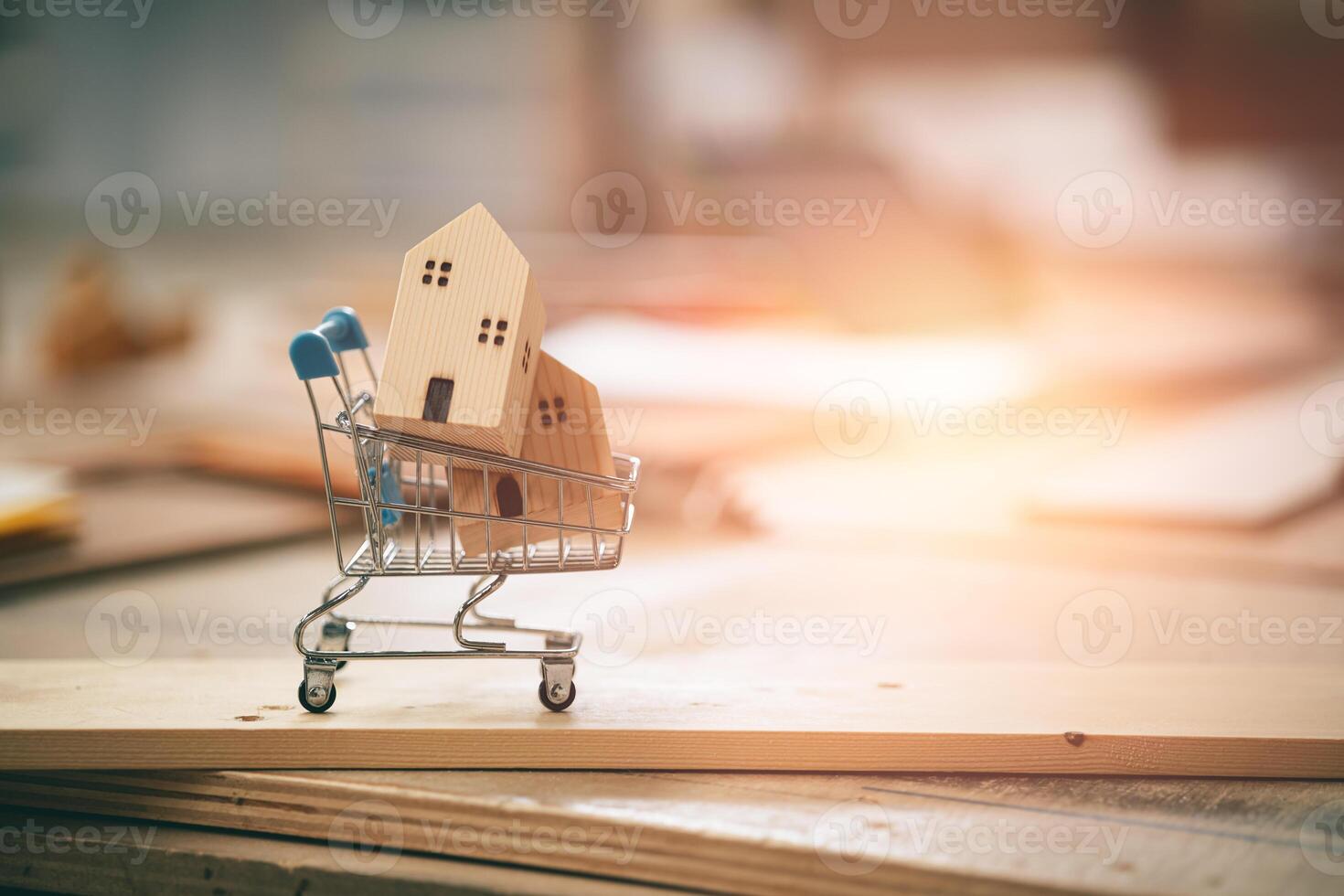 small wood home in shopping cart for buying new home buid wooden house concept with copy space photo