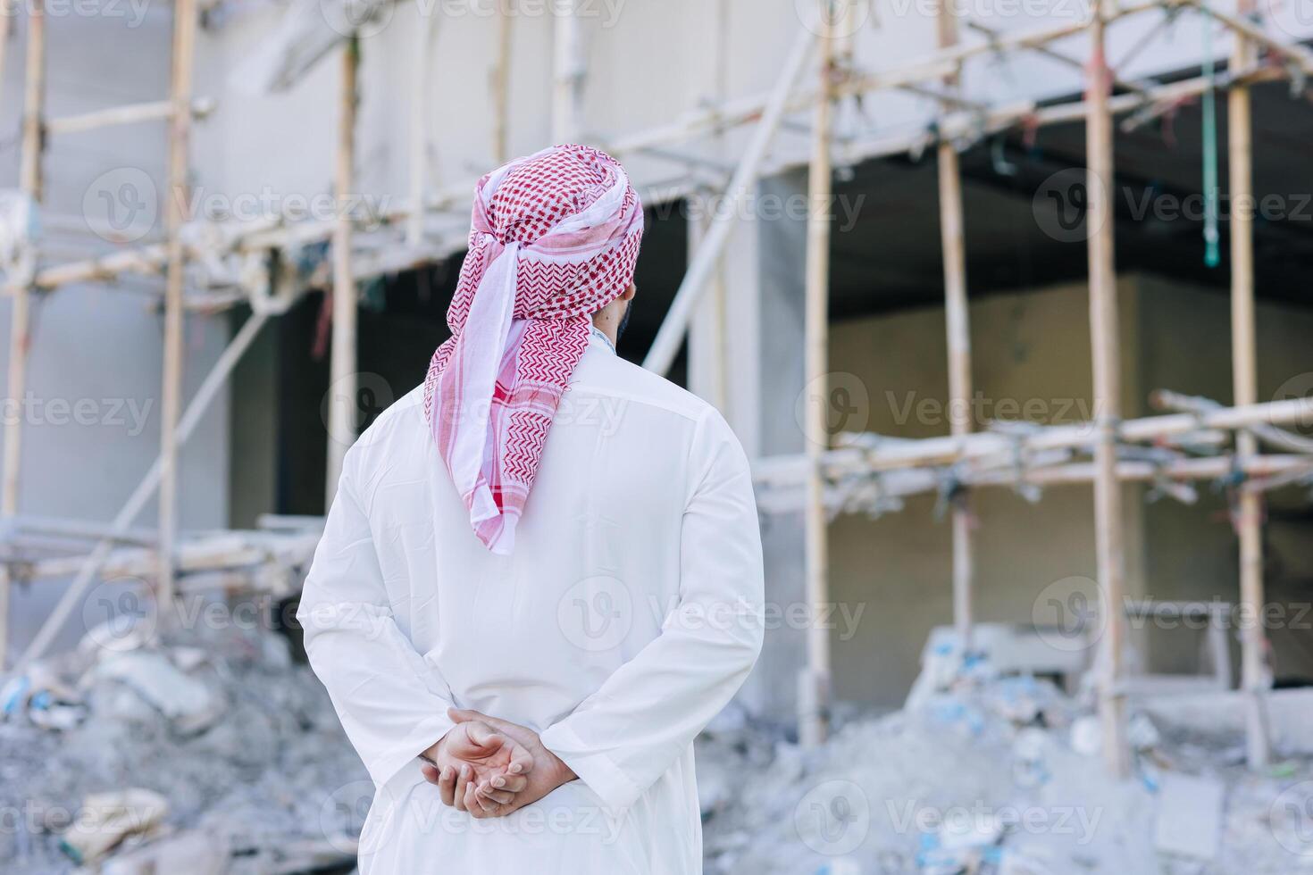 Sheikh Arab man looking at under construction building for build new office business project owner concept photo