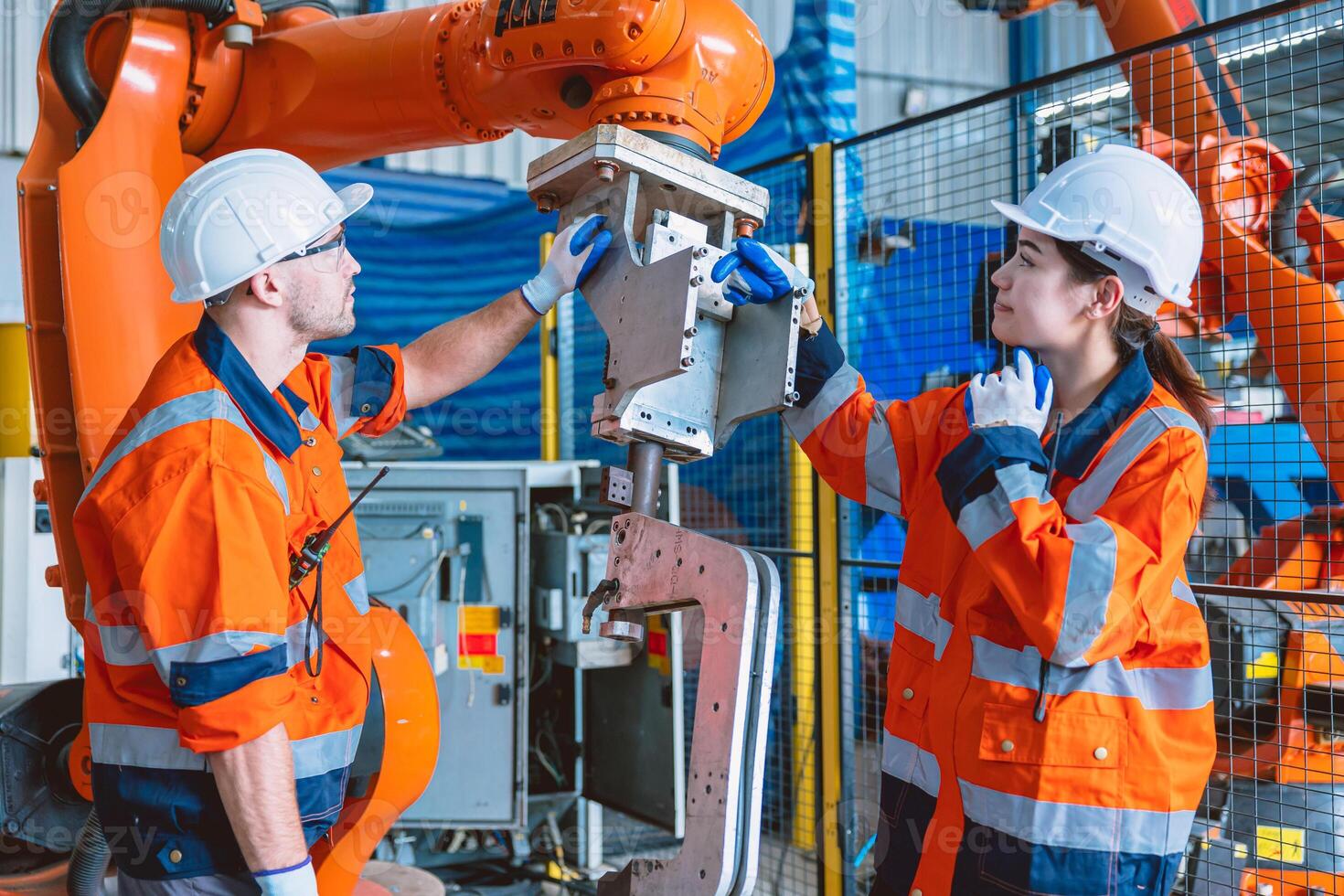 engineer team worker working with robot arm assembly machine in modern metal heavy industry factory photo