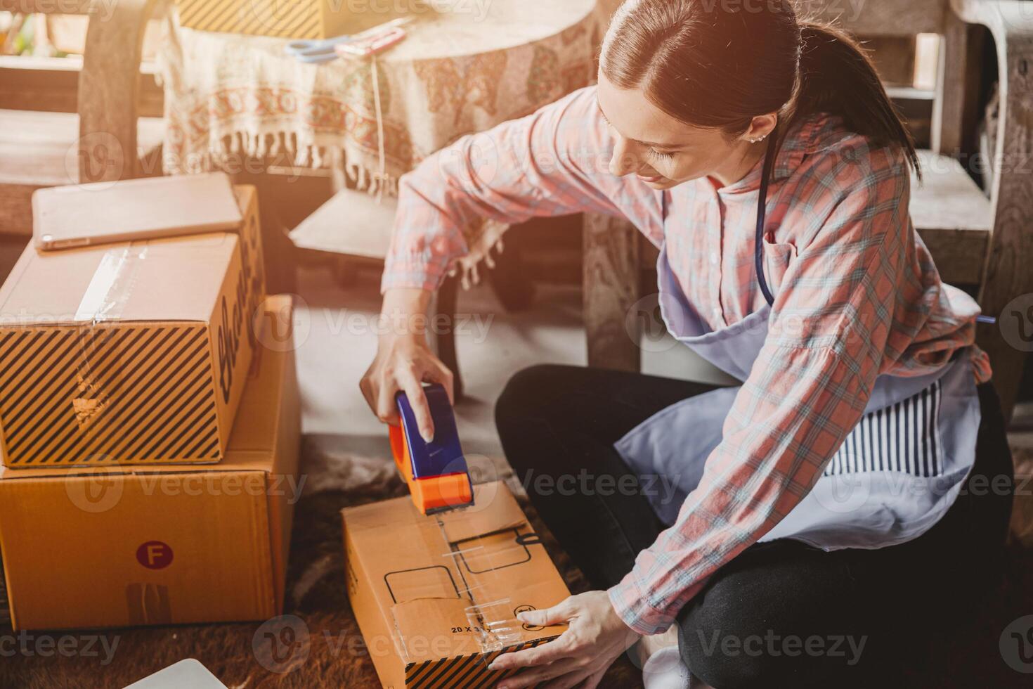 woman packing products order box send to customer freelance work for own business at home vintage tone photo