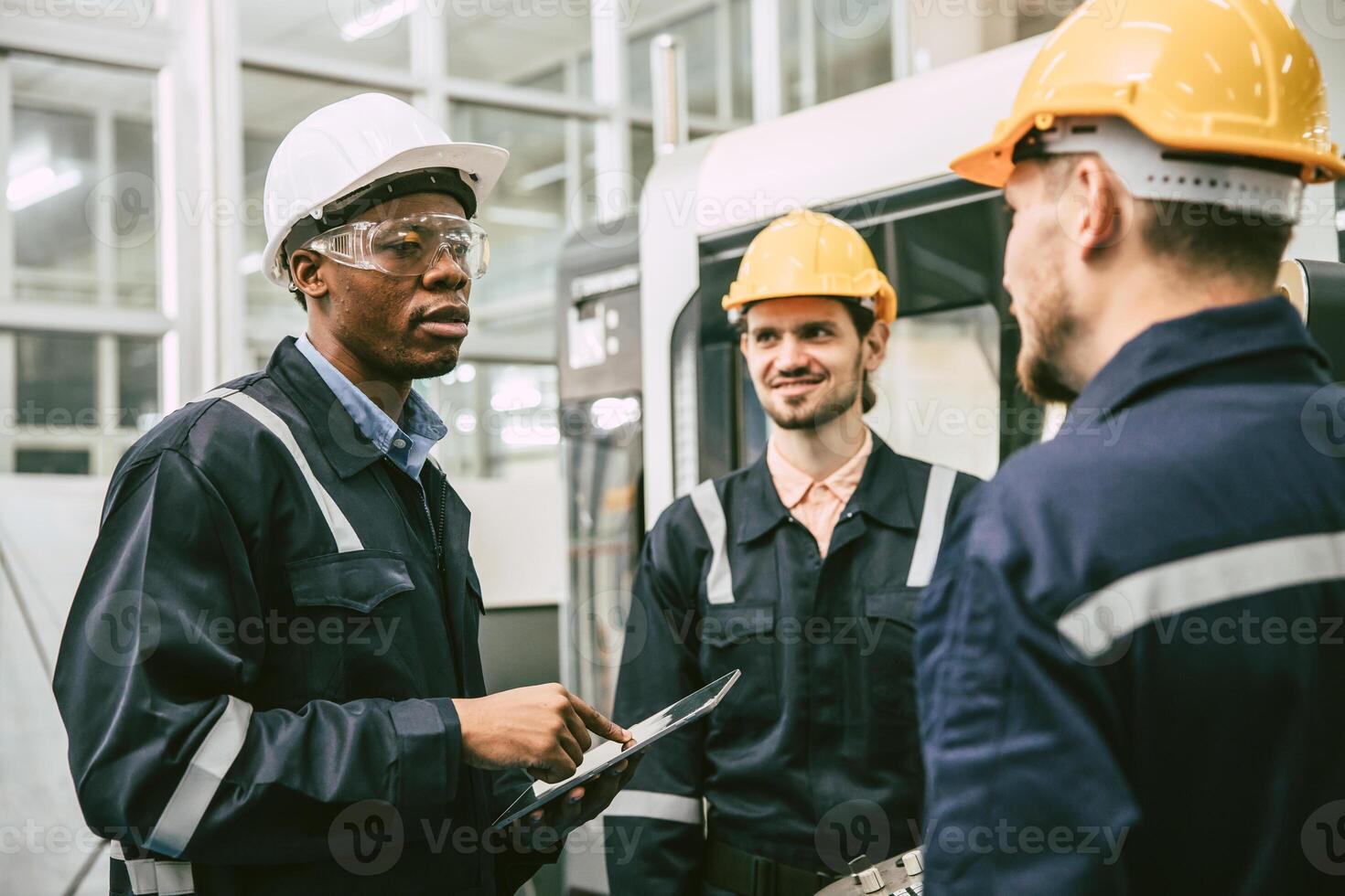 African black male engineer team leader talking with team worker college group in modern factory photo