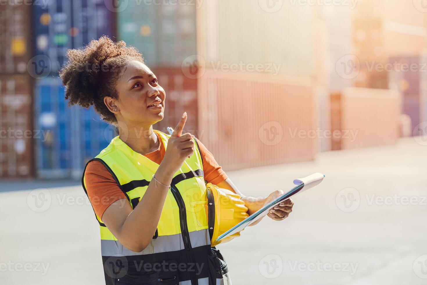 African woman cargo logistics industry staff worker happy working in port shipyard check containers photo