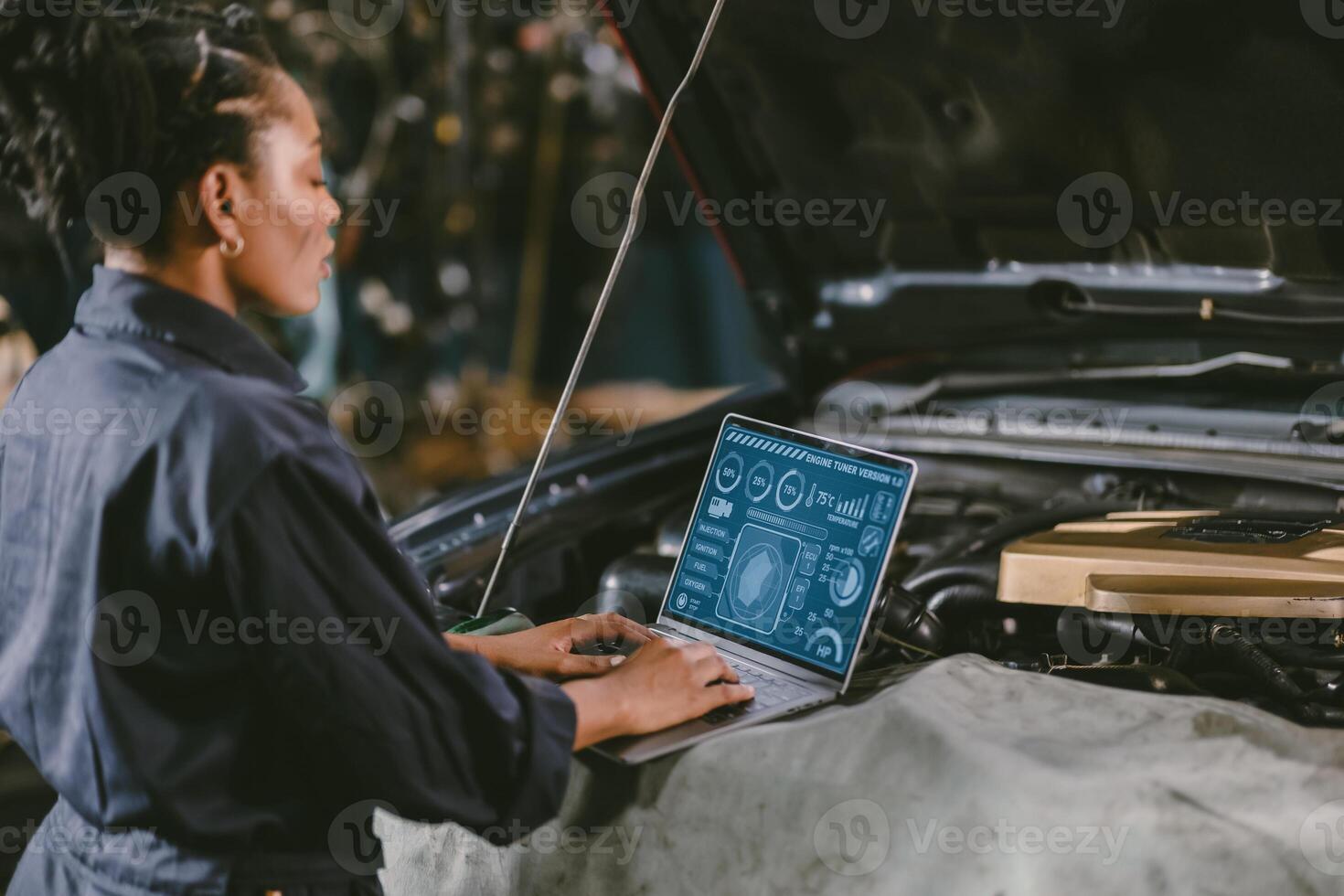 garage mechanic car engine engineer woman staff worker using laptop computer turning engine or check ECU combustion control photo