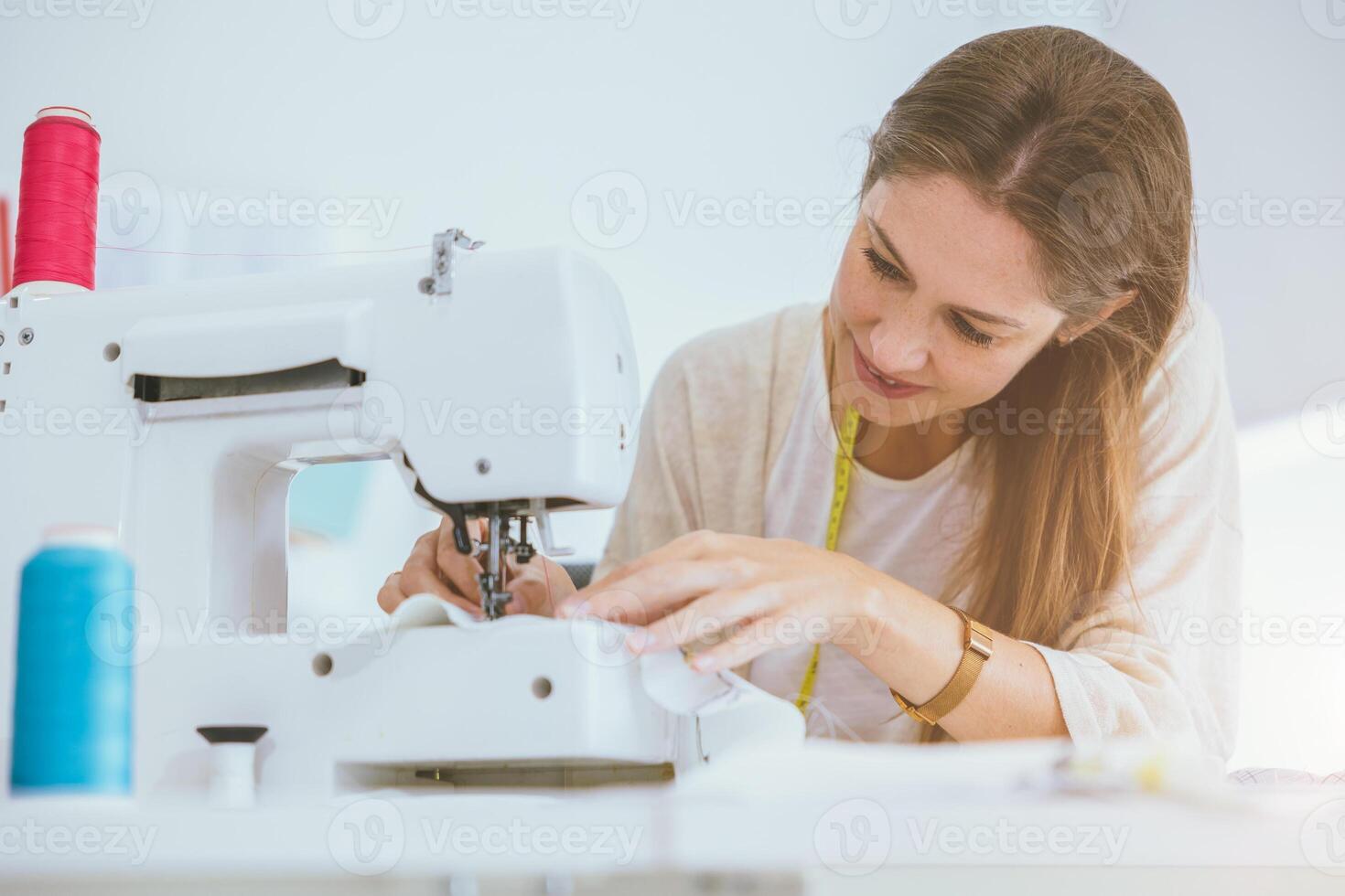 costume professional woman work enjoy with digital sewing machine happy in tailor studio photo