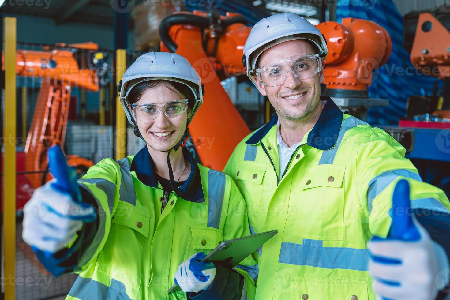happy engineer team portrait thumbs up enjoy working together in modern metal factory with robotic arm photo