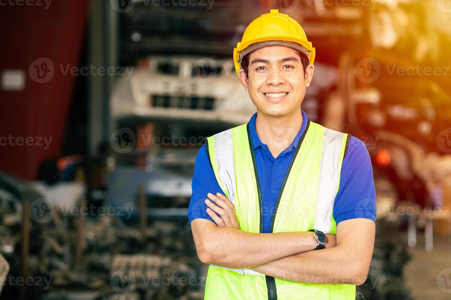 Asian male engineer worker standing arm crossed confident happy smile for enjoy working in factory looking camera photo