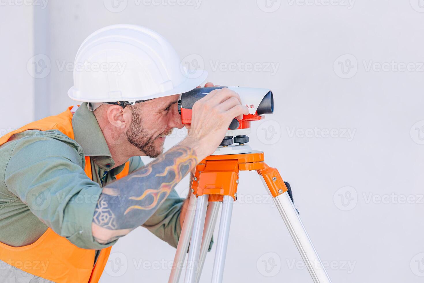 Engineer builder working with Auto Level camera look aim levelling survey construction building floor photo