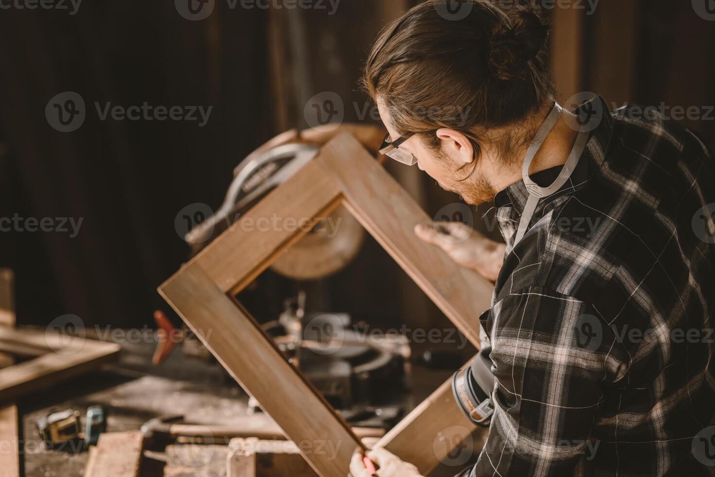 carpenter male wood builder worker making wooden furniture job in workshop photo