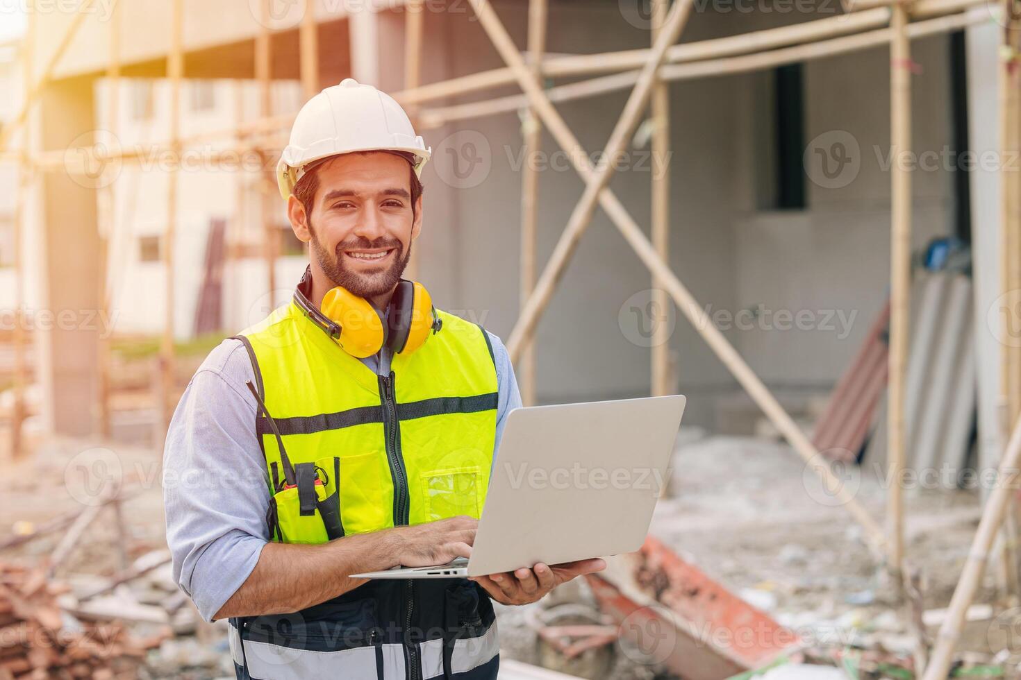 portrait happy builder foreman work in construction site. senior worker project designer leader concept. photo