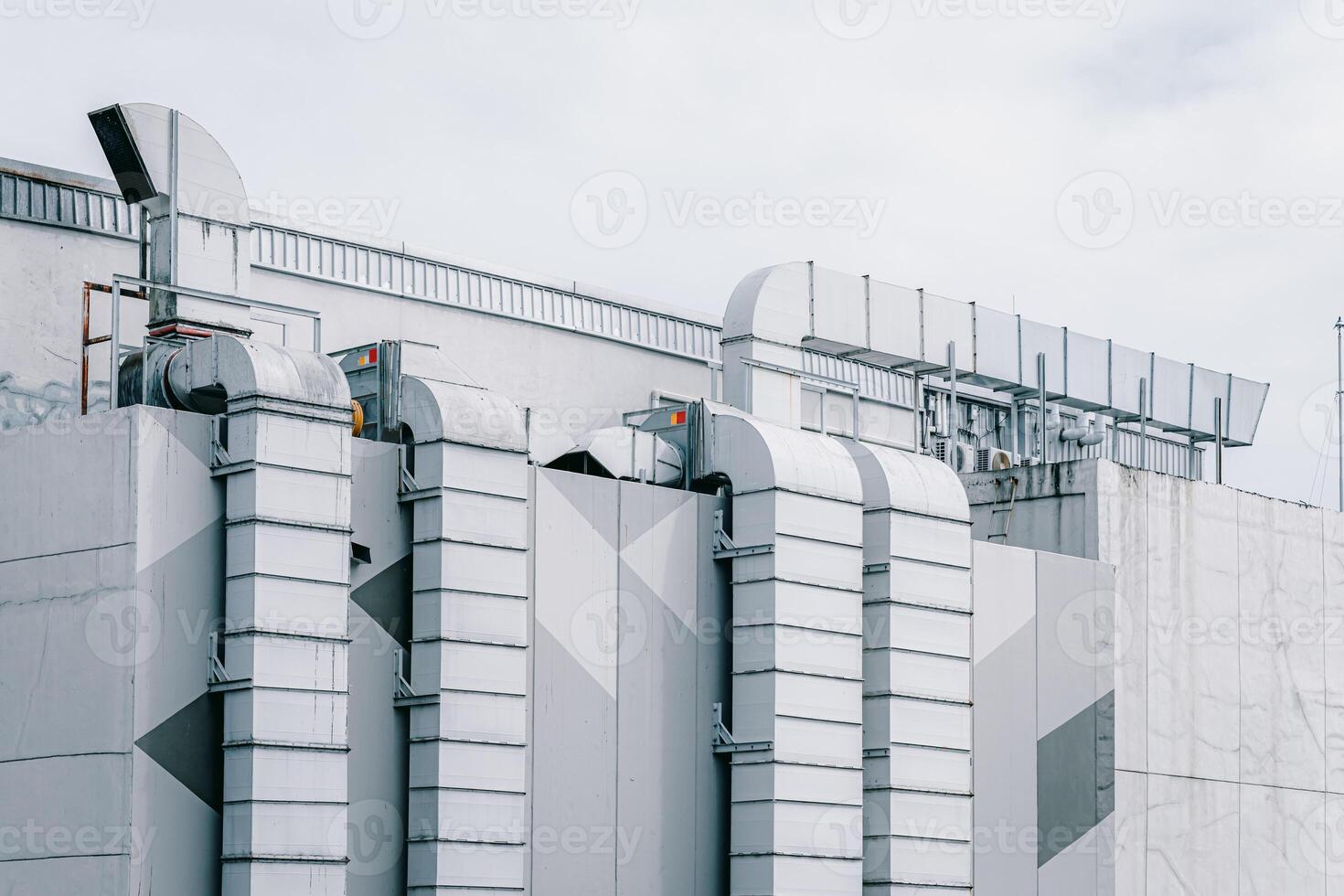 Rooftop air vent ways flow ventilator system. air conditioner pipe line in large mall building city landscape outdoors photo