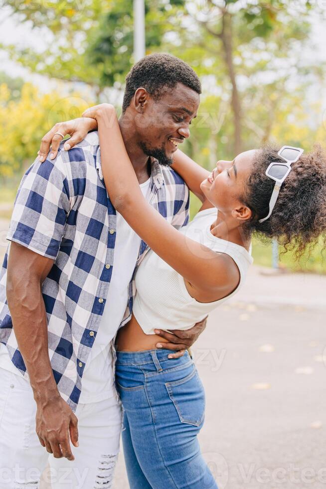 Date couple man and women valentine day. African black lover at park outdoors summer season vintage color tone photo