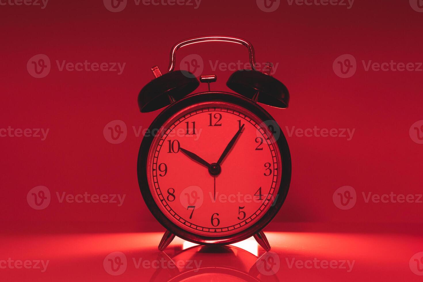Analog time clock on red light color for times up hurry warning dangerous hours concept photo