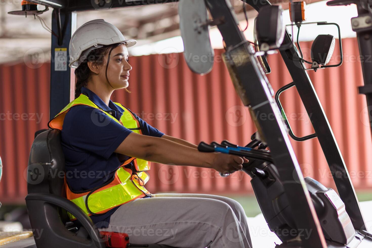 Indian woman staff worker work forklift driver at port cargo warehouse container yard for logistics industry happy smile photo