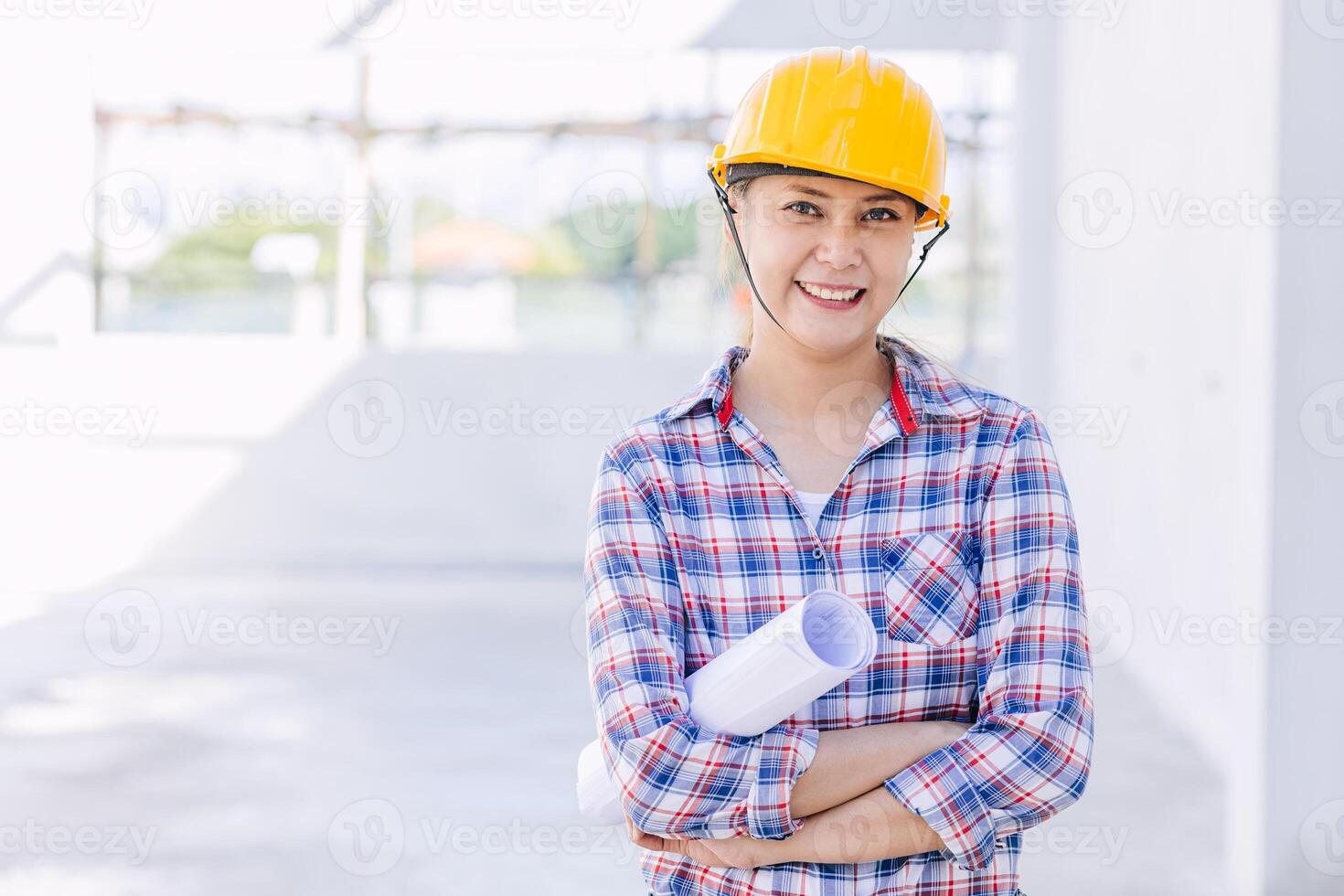 Engineer builder woman worker foreman. Portrait Asian girl architect home designer with floor plan. photo