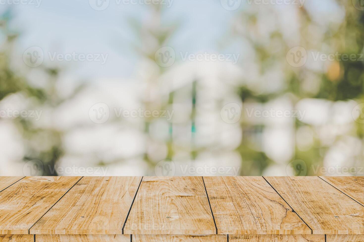 Wooden table space with green home backyard outdoor blur background for advertising montage template photo