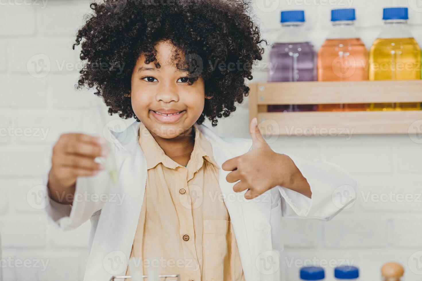 Portrait Scientist Kid in school with science lab kit. Learning education black child girl happy smiling thumbs up. photo