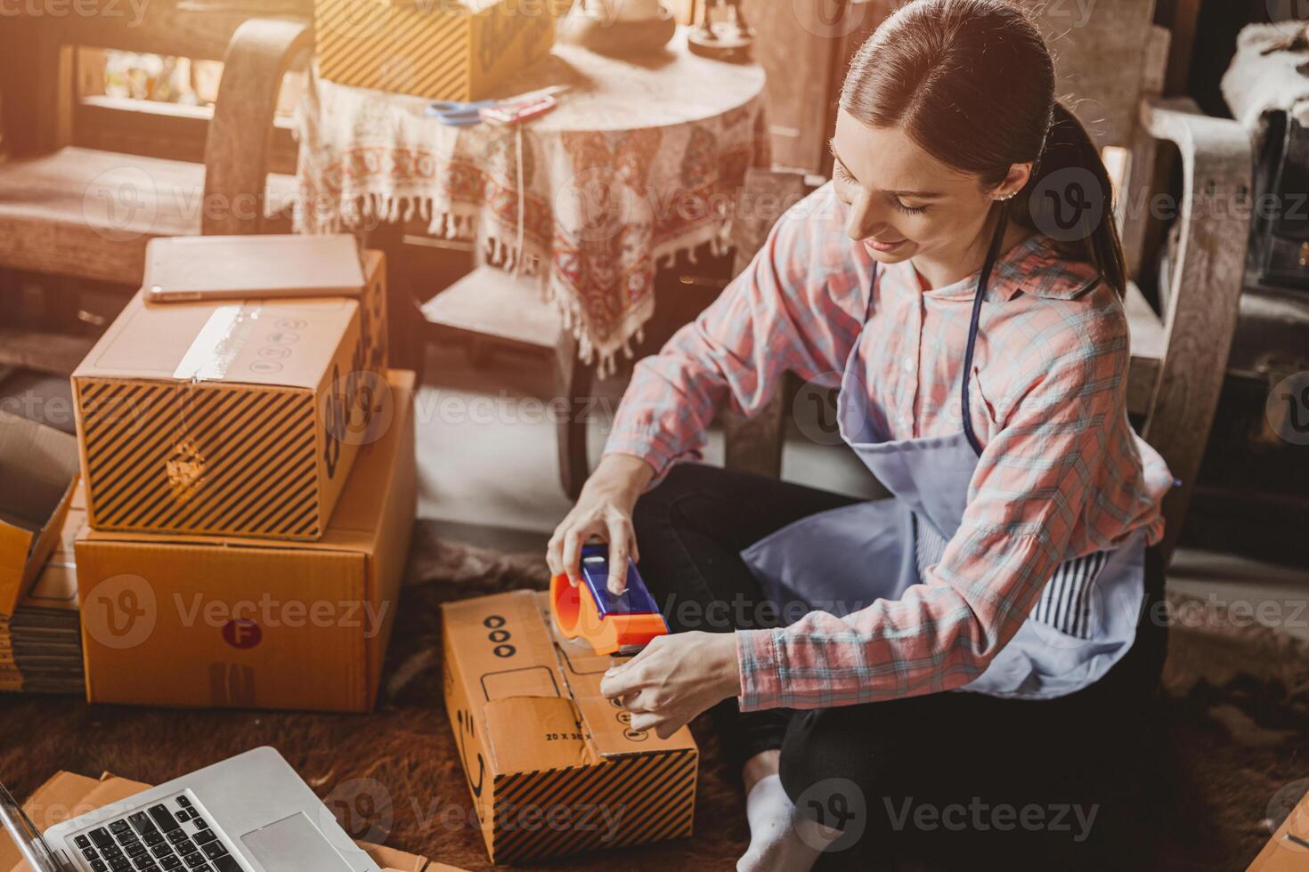 woman packing products order box send to customer freelance work for own business at home vintage tone photo