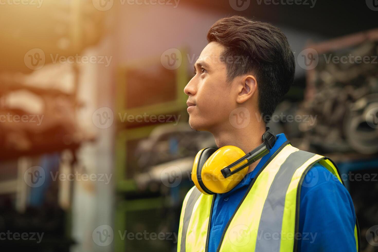 Confident proud Asian male engineer worker standing happy smile for enjoy working in factory photo