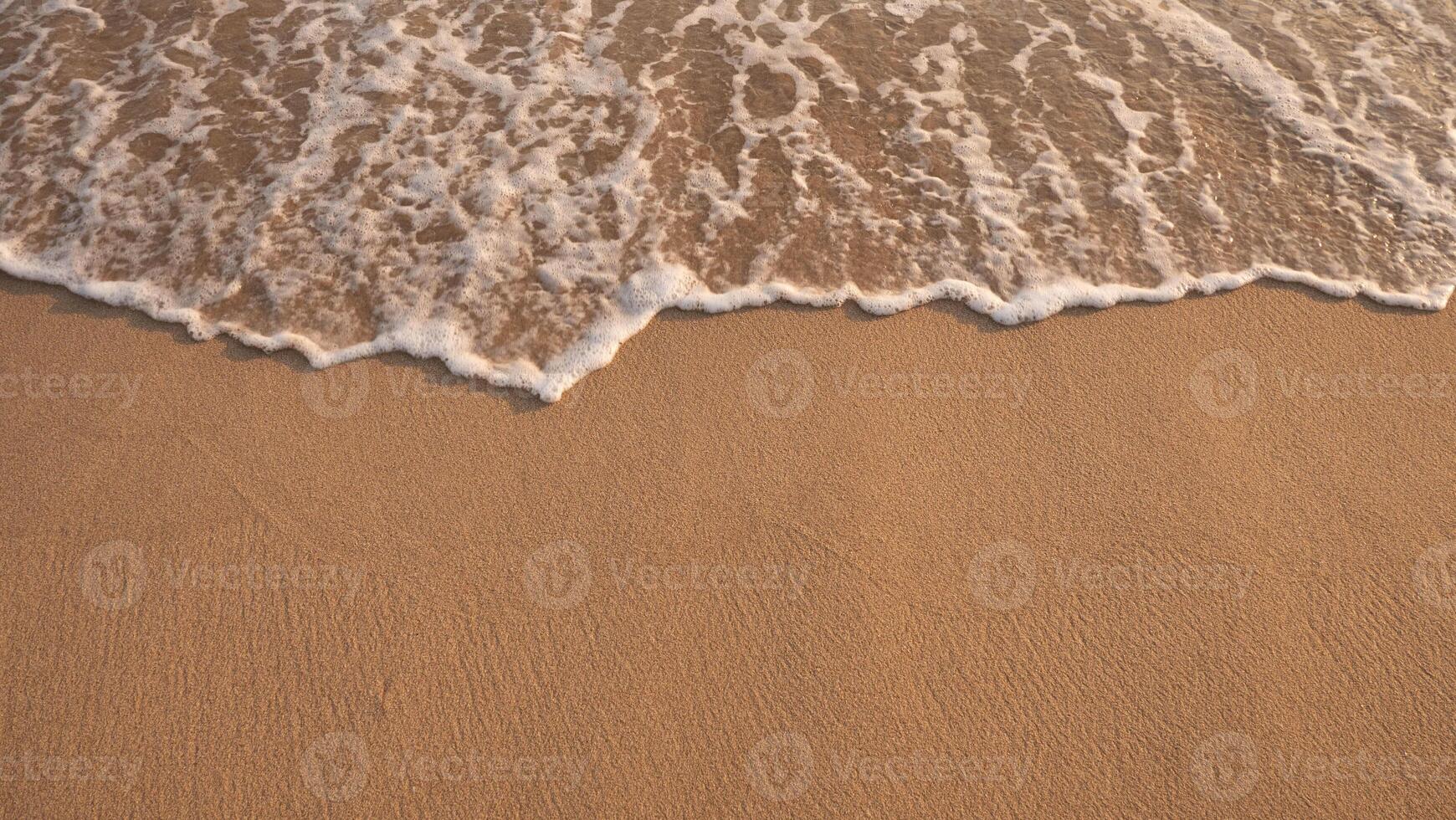 White foamy background of waves crashing on a sandy beach. photo