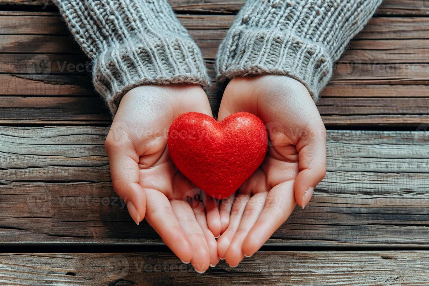 ai generado un par de manos sostiene un pequeño rojo corazón conjunto en contra el fondo de un rústico de madera superficie foto