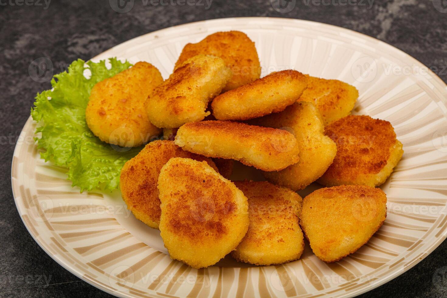 Fried chicken nuggets served salad leaves photo