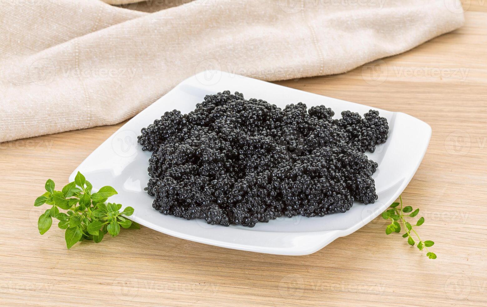 Black caviar in the plate photo