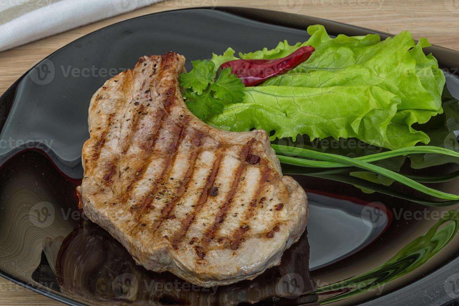 Grilled t-bone steak in the plate photo