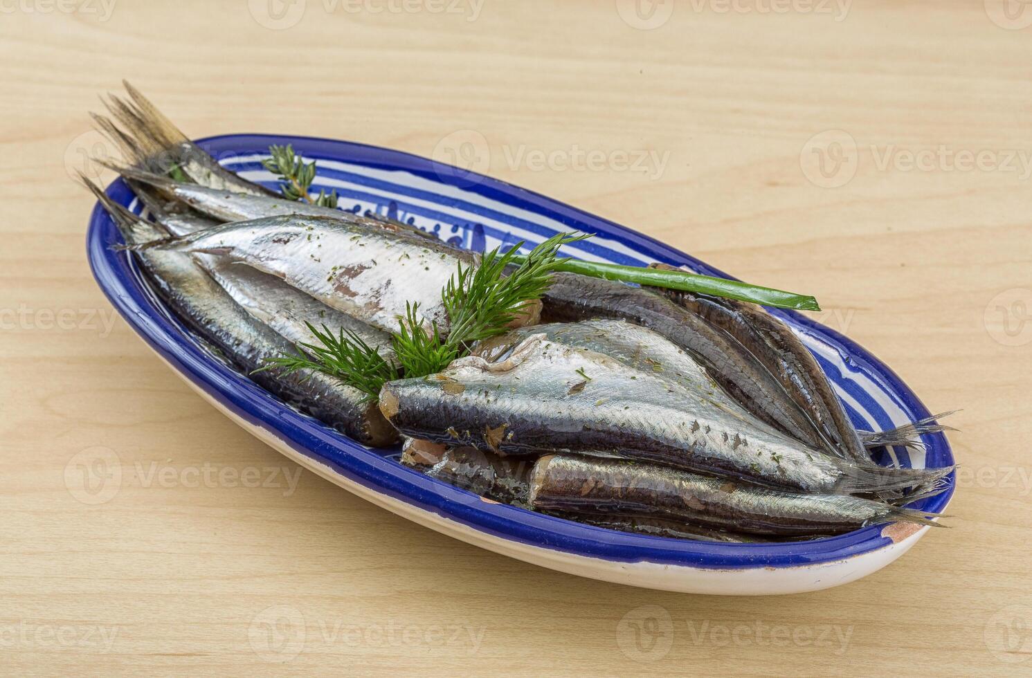 Salted anchovy in the plate photo