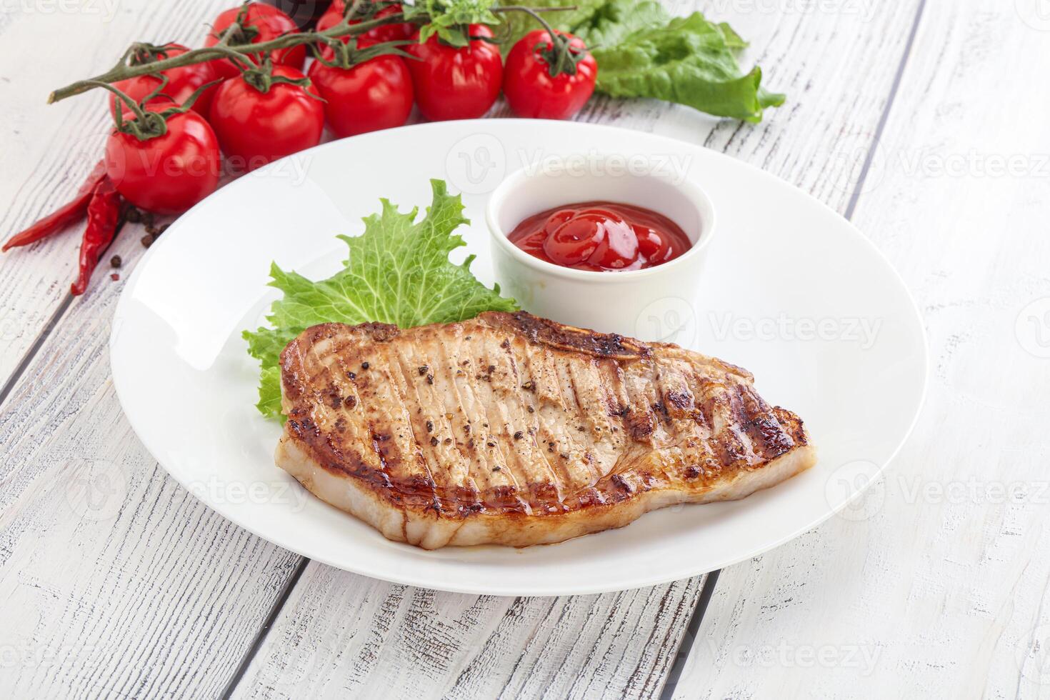 Grilled pork steak with ketchup photo