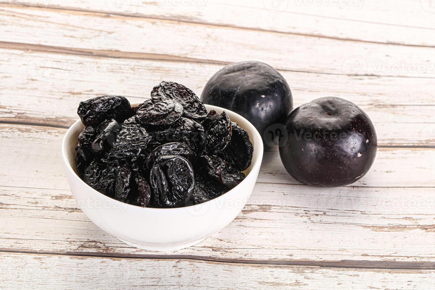 Dry prunes in thw bowl photo