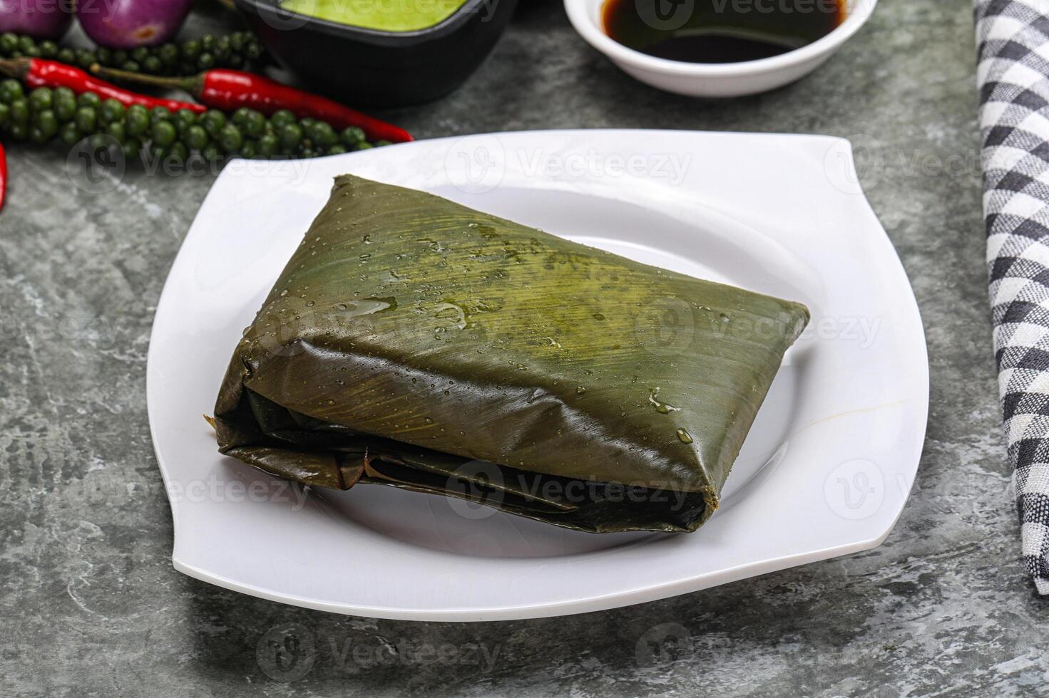 Asian cuisine - rice with filling in banana leaf photo