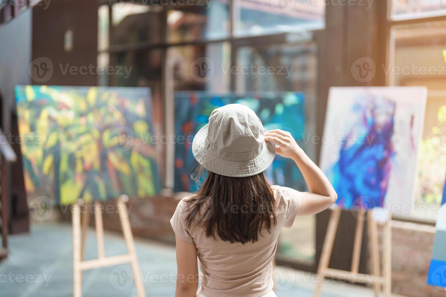 Young female tourist looking gallery exhibition. Art, Painting, photography, Inspiration and museum concept photo