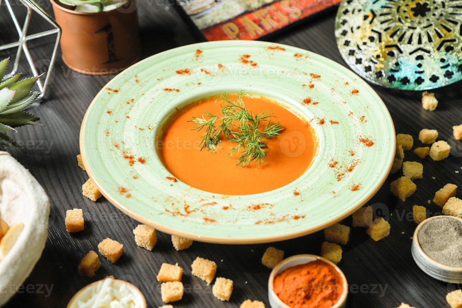 Carrot Soup With Croutons on Table photo