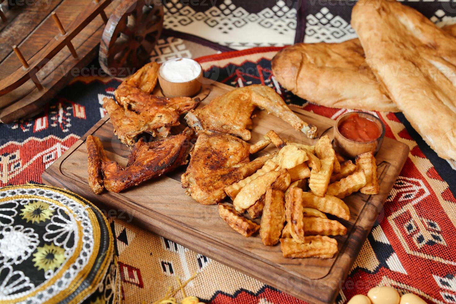Wooden Plate With French Fries and Assorted Food Items photo