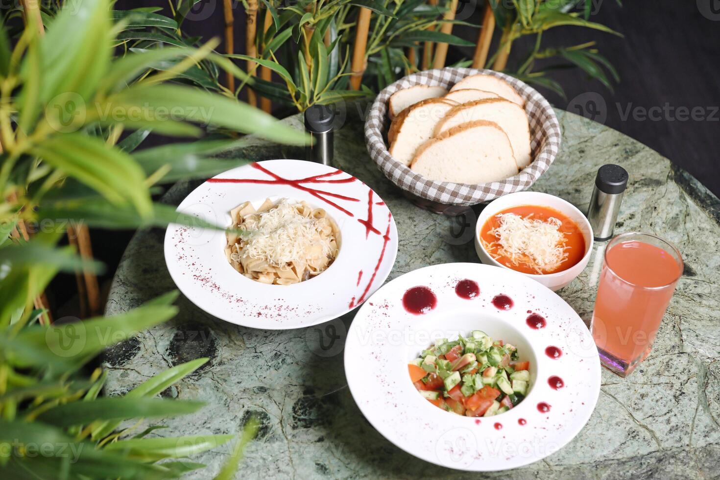 Table With Assorted Food Plates and Soup Bowls photo