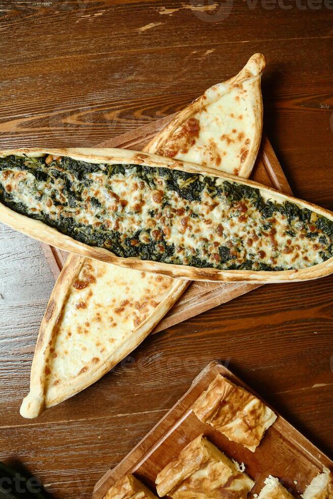 Pizza Slice on Wooden Table photo