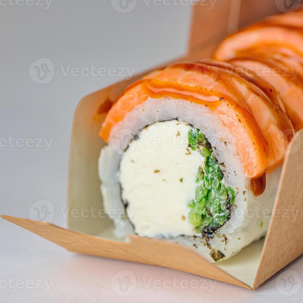 Sauce-drenched Sushi Roll With a Variety of Toppings. photo