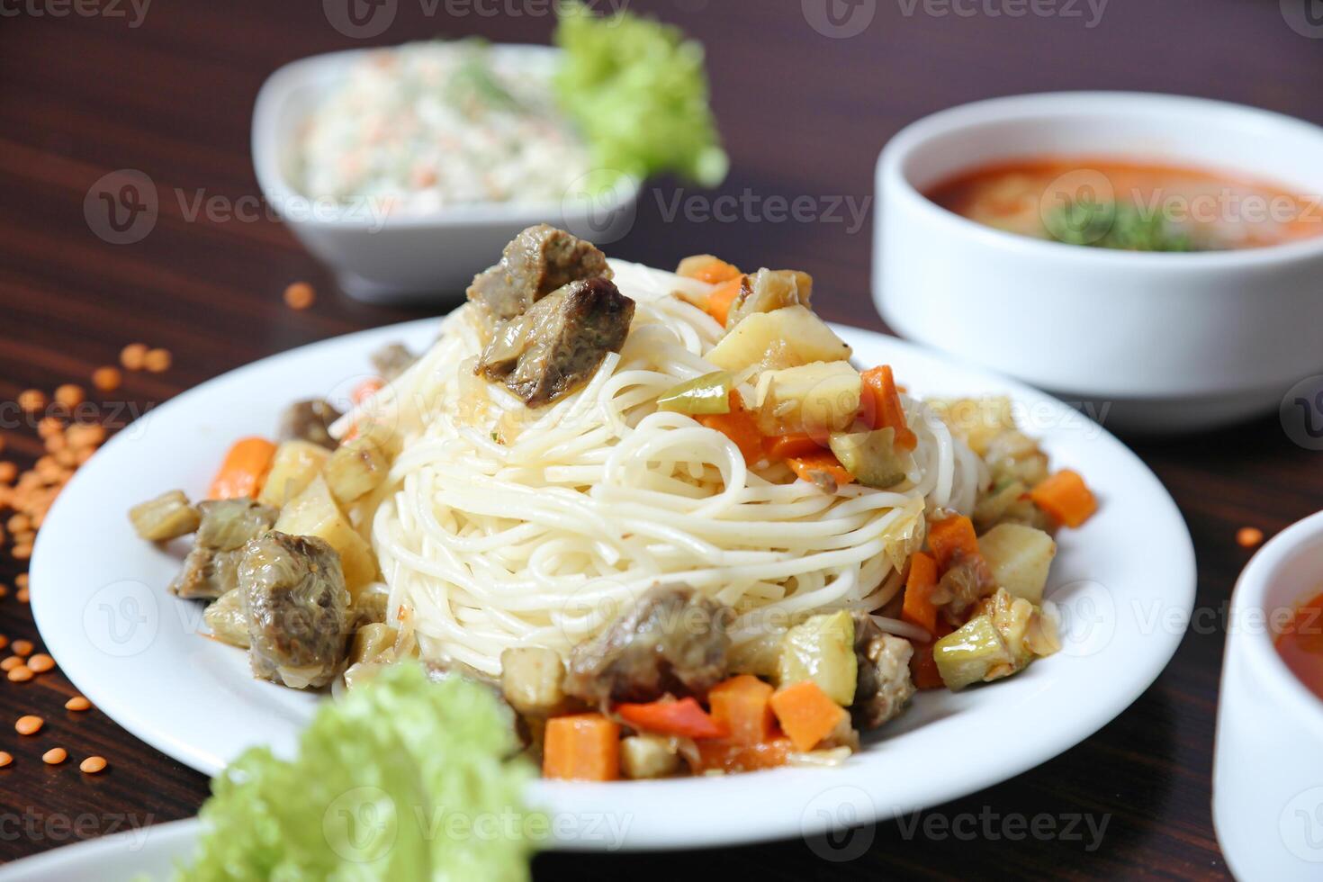 Table Showcasing Various Plates of Food and Bowls of Soup. photo
