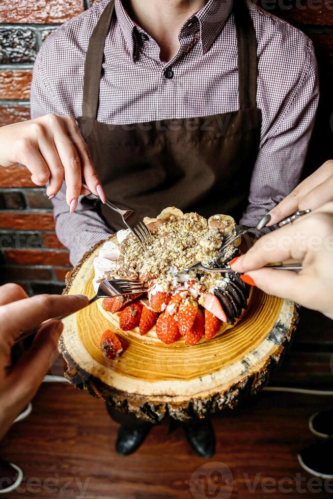 Person Cutting Into a Cake With a Knife and Fork photo