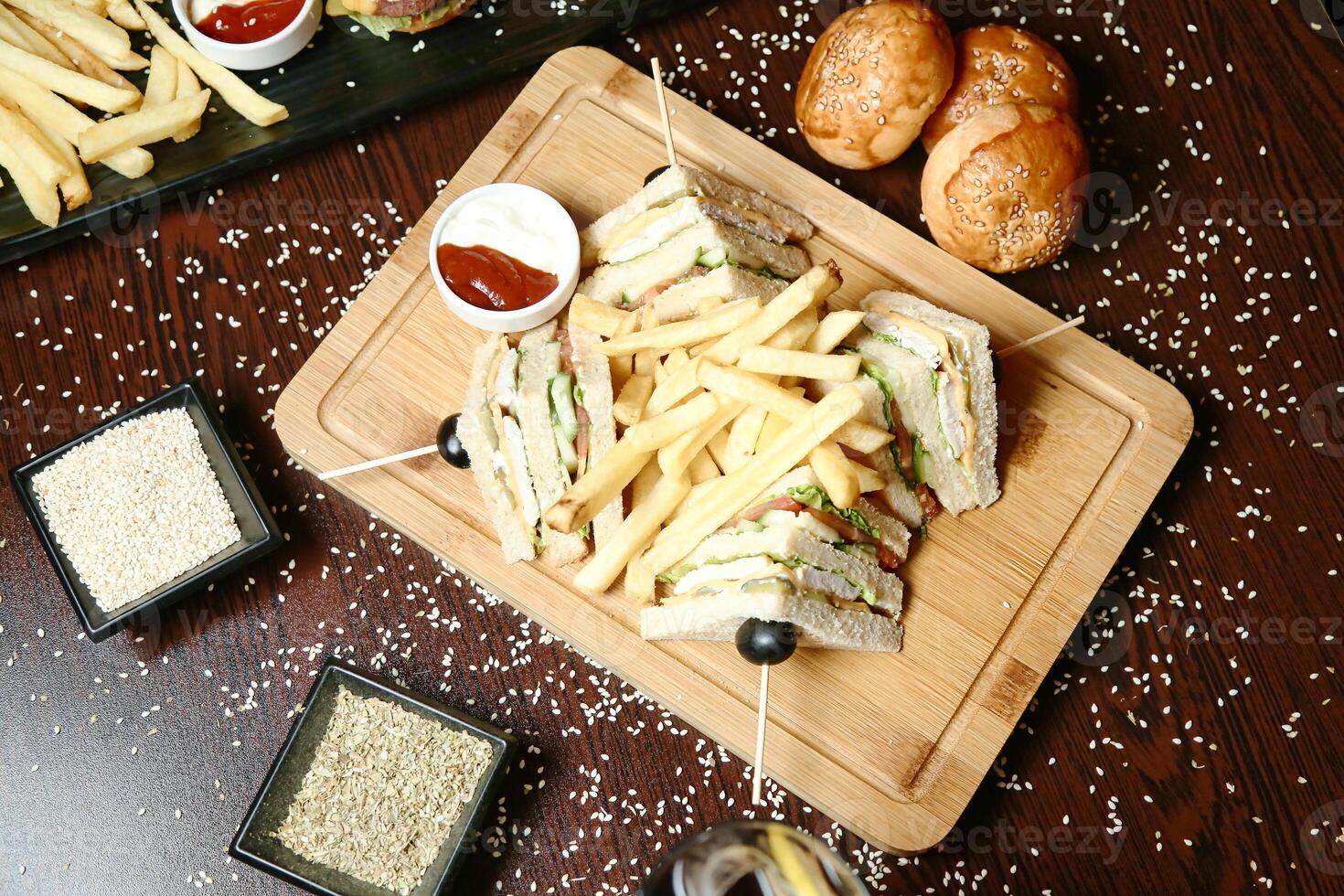 Wooden Cutting Board With Sandwich and French Fries photo