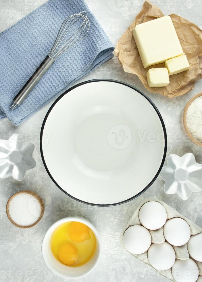 Ingredients and kitchen utensils for making homemade cakes. Home kitchen. Copy space. Flat lay. photo