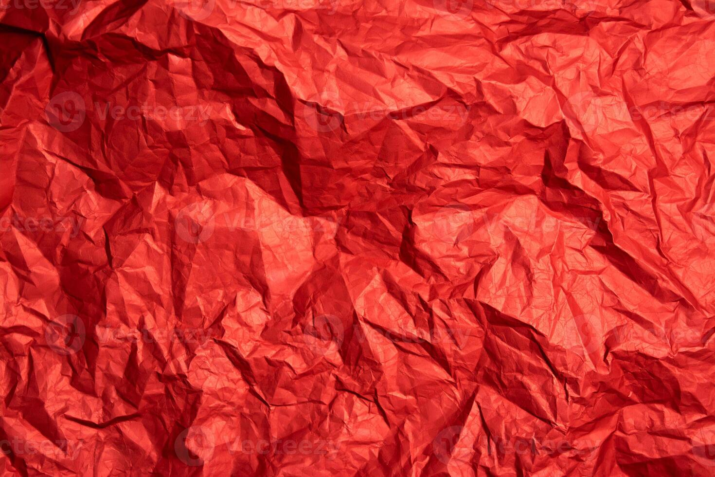 Crumpled red sheet of paper. Paper texture. Background for designers. Paper layout. photo