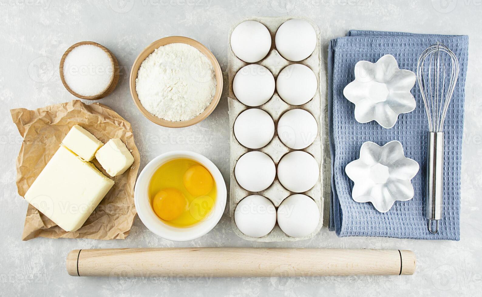 Ingredients and utensils for making homemade cakes. Home kitchen. Copy space. Food knolling. The apartment was lying. photo